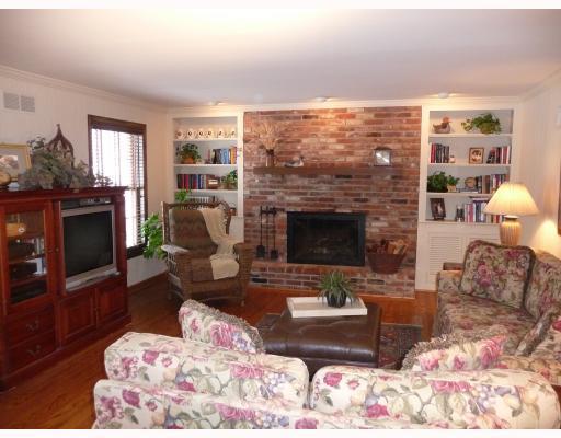 136 Saunders Road Trafford, PA 15085 - Photo 4 of 18 Den/Family/Great Room. Gas or Wood working fireplace with spot lights / great new hard wood flooring/built-in bookcases