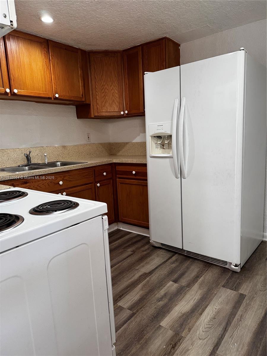 1330 West 54th Street, Unit 205C Hialeah, FL 33012 - Photo 3 of 10 a kitchen with a refrigerator sink and cabinets