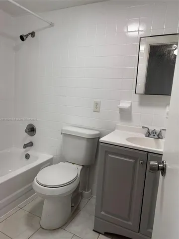 a bathroom with a toilet a sink and bathtub
