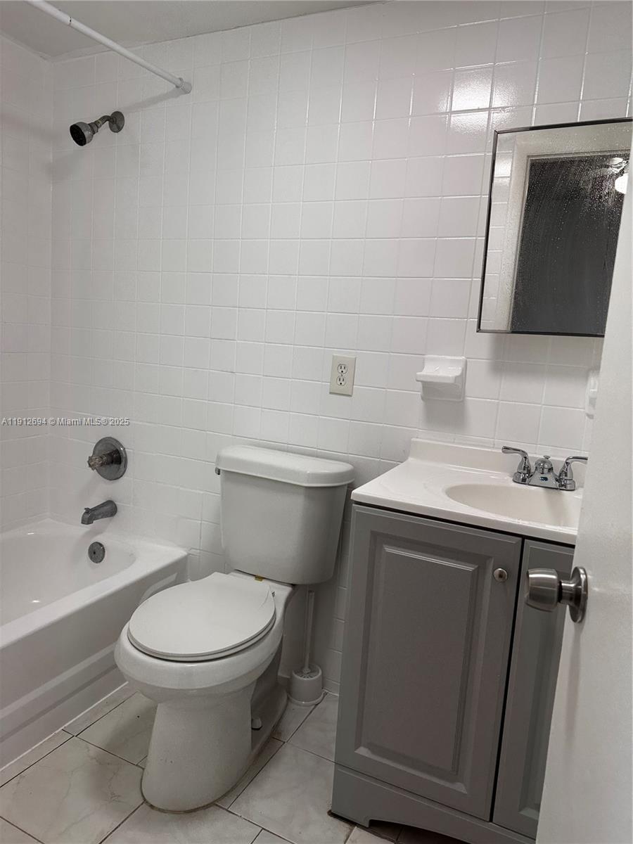 1330 West 54th Street, Unit 205C Hialeah, FL 33012 - Photo 5 of 10 a bathroom with a toilet a sink and bathtub