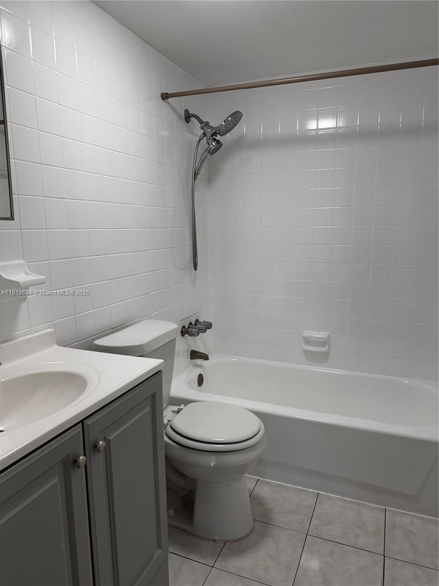1330 West 54th Street, Unit 205C Hialeah, FL 33012 - Photo 6 of 10 a bathroom with a sink a toilet and shower