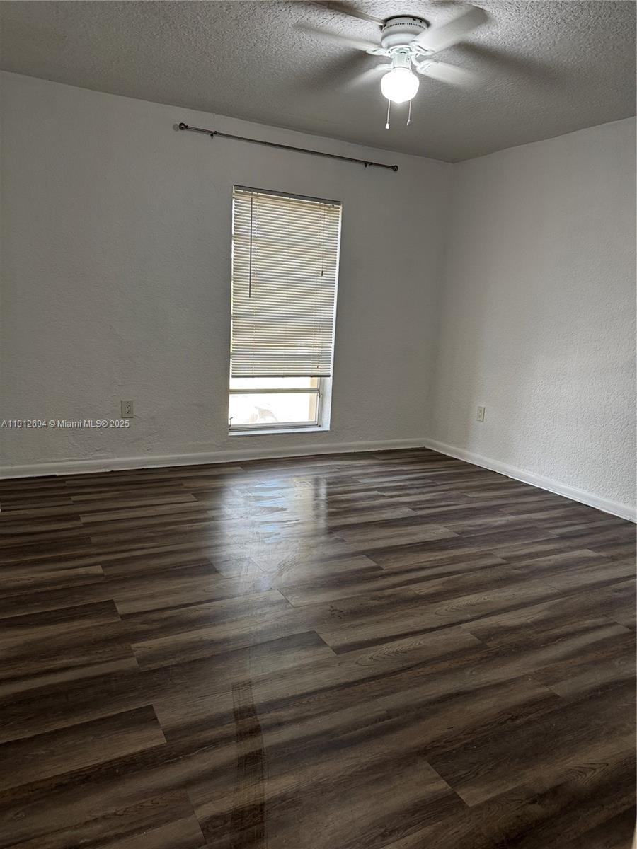 1330 West 54th Street, Unit 205C Hialeah, FL 33012 - Photo 7 of 10 wooden floor in an empty room with a window