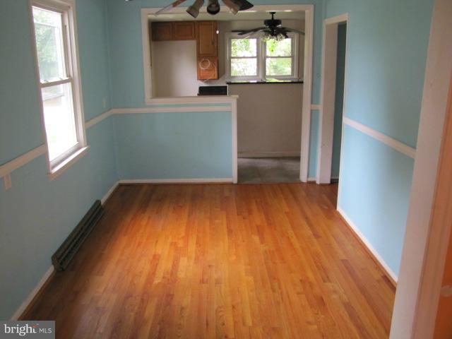 4607 Morgan Road Morningside, MD 20746 - Photo 3 of 13 wooden floor in an empty room with a window