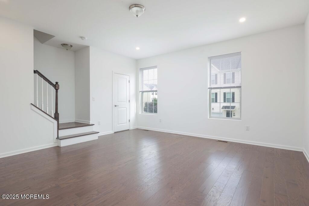 100 Revival Road Brick, NJ 08723 - Photo 17 of 38 an empty room with wooden floor and windows