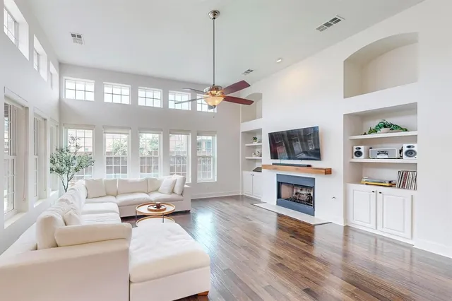 a living room with furniture a flat screen tv and a fireplace