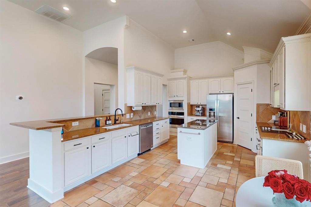9964 Madrone Drive Frisco, TX 75033 - Photo 12 of 39 a kitchen with a sink a counter top space stainless steel appliances and cabinets