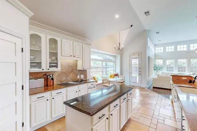 a kitchen with granite countertop a sink and a stove
