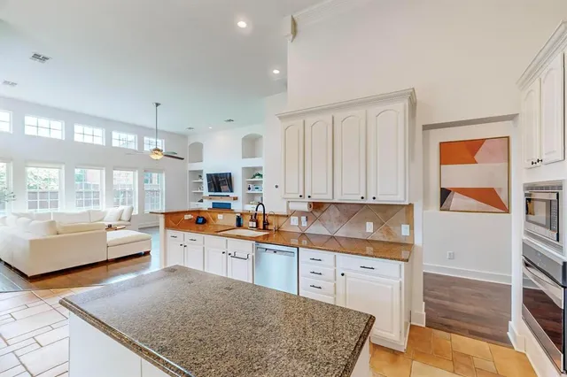 a kitchen with a sink a stove and cabinets