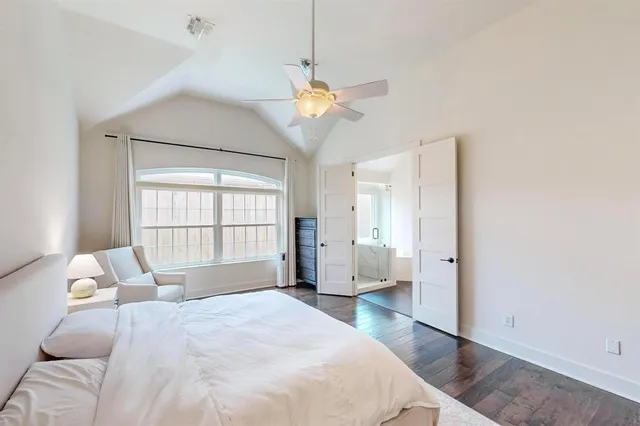 a spacious bedroom with a bed and a window