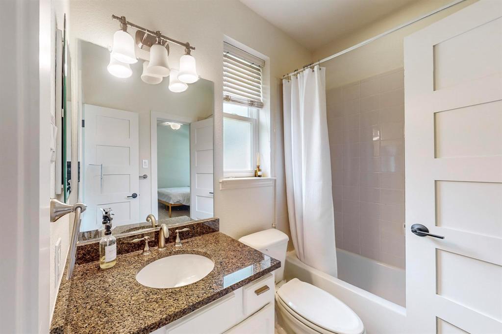 9964 Madrone Drive Frisco, TX 75033 - Photo 25 of 39 a bathroom with a granite countertop sink toilet mirror and shower