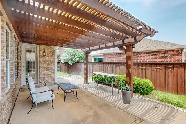 a building outdoor space with patio furniture and potted plants