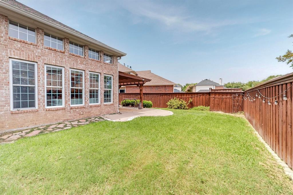 9964 Madrone Drive Frisco, TX 75033 - Photo 37 of 39 a view of house with backyard and a garden