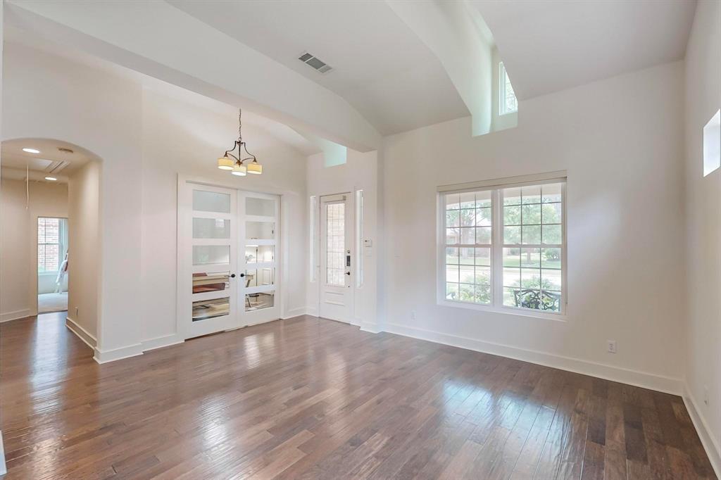 9964 Madrone Drive Frisco, TX 75033 - Photo 8 of 39 an empty room with wooden floor and windows