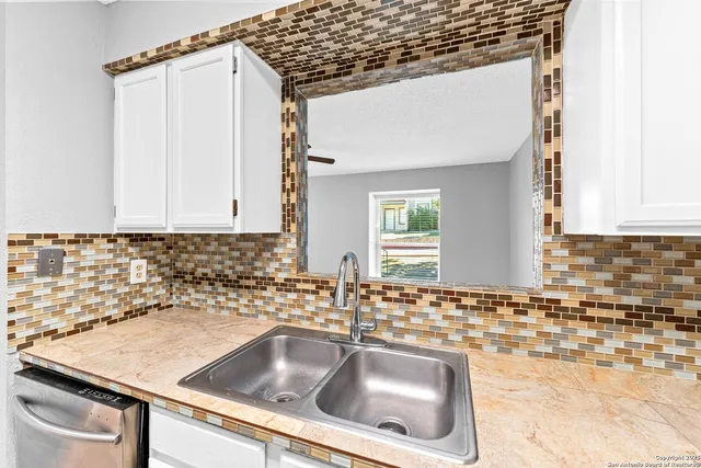 a kitchen with a sink and cabinets