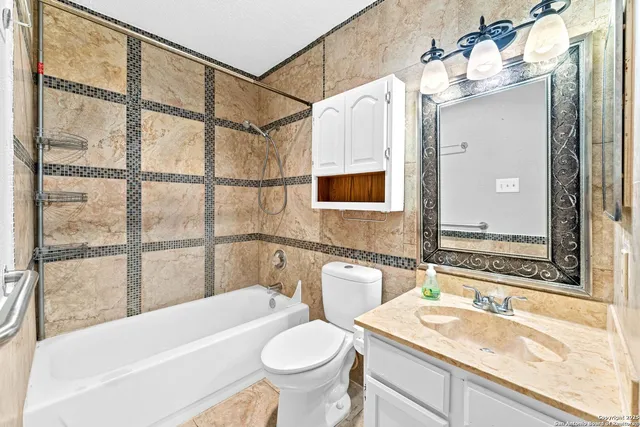 a bathroom with a sink a toilet and bathtub