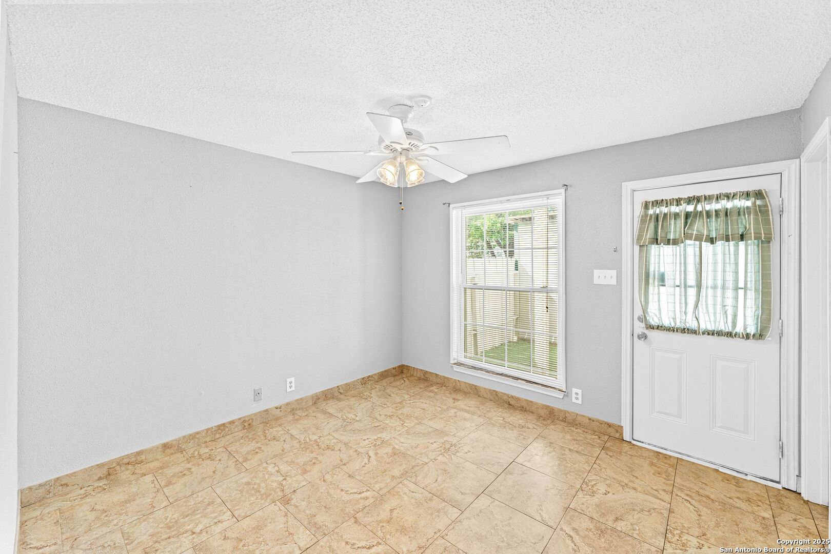4949 Hamilton Wolfe Road, Unit 8104 San Antonio, TX 78229 - Photo 20 of 27 an empty room with chandelier fan and windows