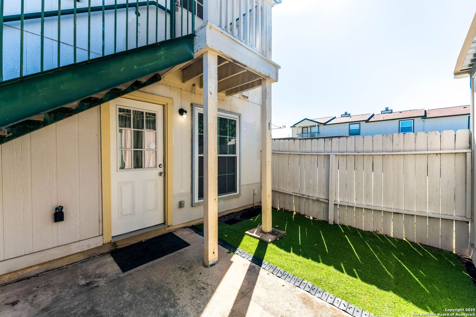4949 Hamilton Wolfe Road, Unit 8104 San Antonio, TX 78229 - Photo 21 of 27 a view of a small garden with wooden fence