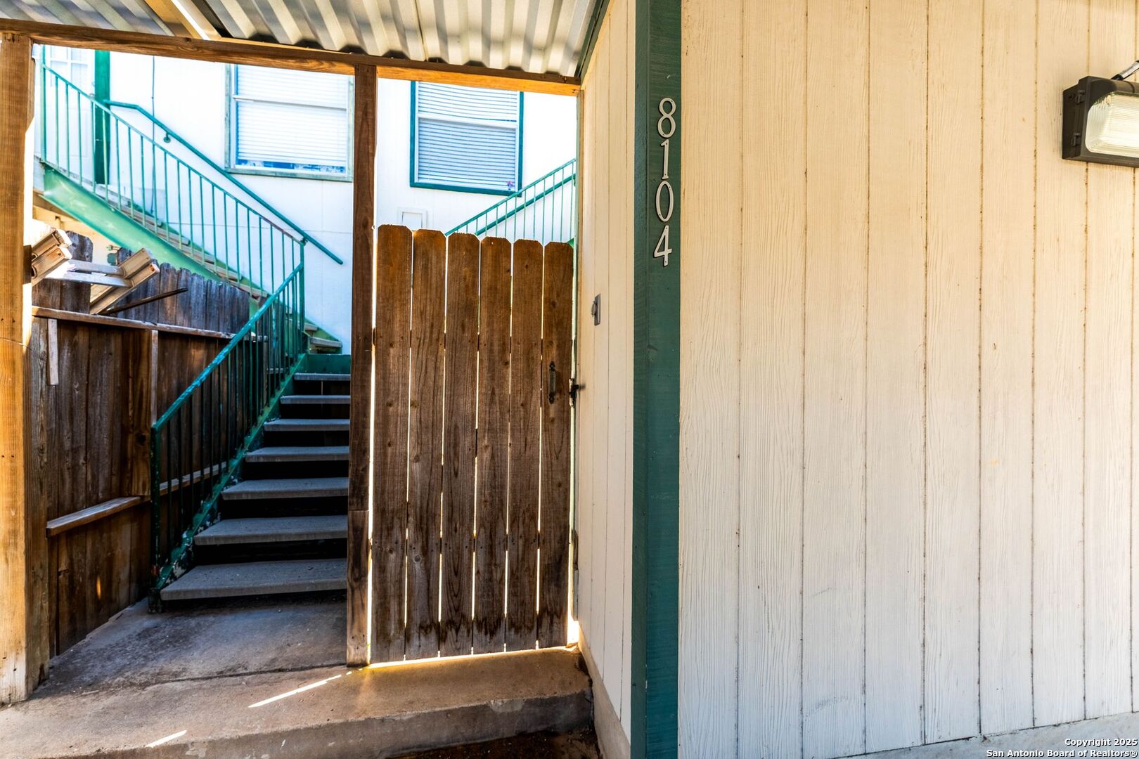 4949 Hamilton Wolfe Road, Unit 8104 San Antonio, TX 78229 - Photo 22 of 27 a view of staircase with railing and a window