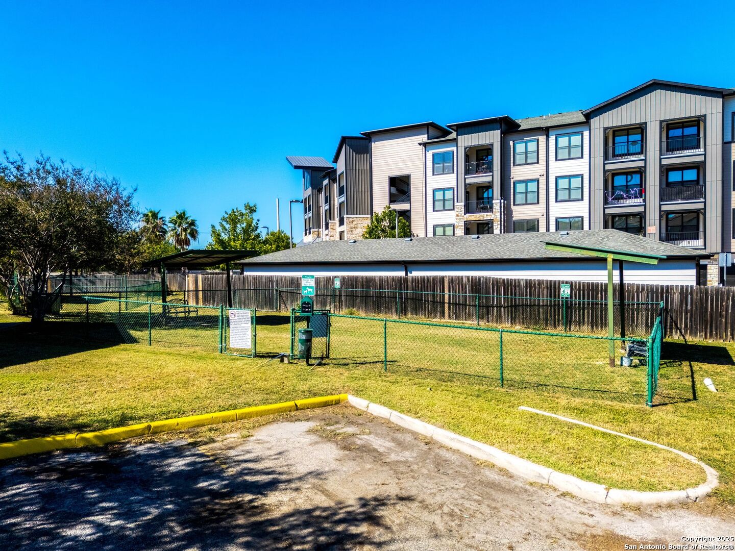 4949 Hamilton Wolfe Road, Unit 8104 San Antonio, TX 78229 - Photo 24 of 27 a view of a swimming pool with an outdoor seating and a yard