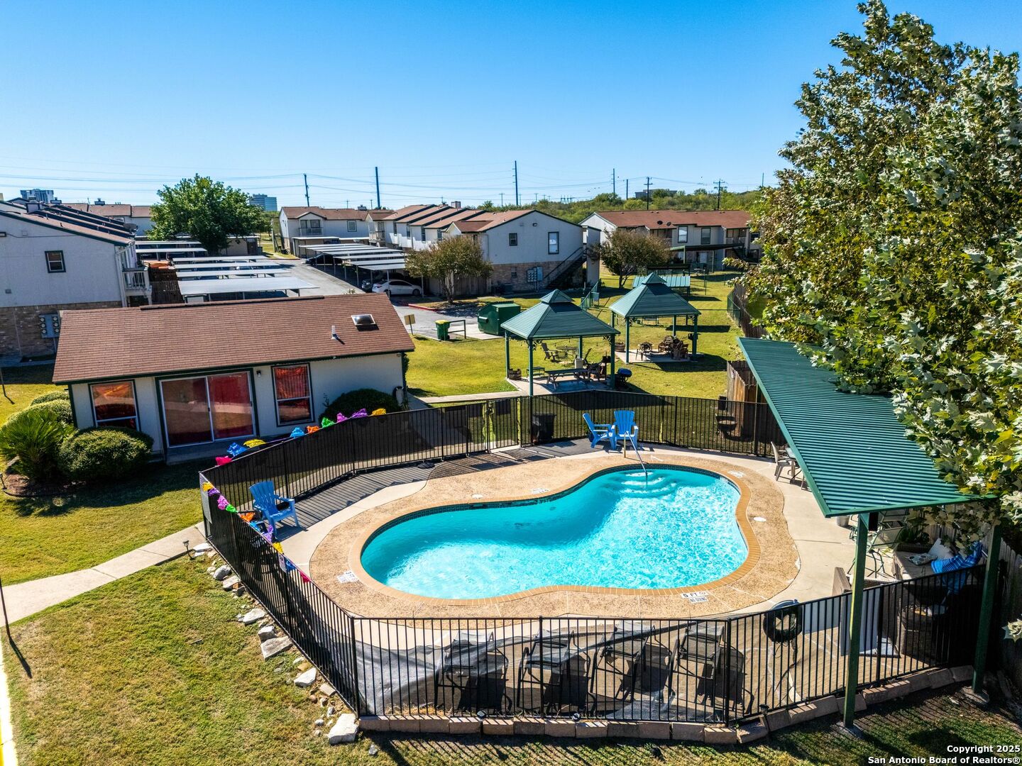 4949 Hamilton Wolfe Road, Unit 8104 San Antonio, TX 78229 - Photo 27 of 27 an aerial view of a house with swimming pool and large trees