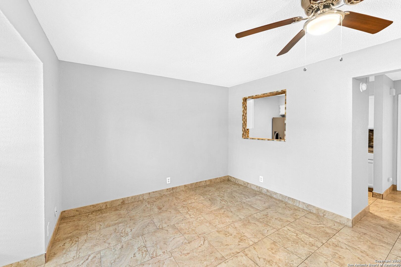 4949 Hamilton Wolfe Road, Unit 8104 San Antonio, TX 78229 - Photo 9 of 27 a view of a big room with wooden floor and a ceiling fan