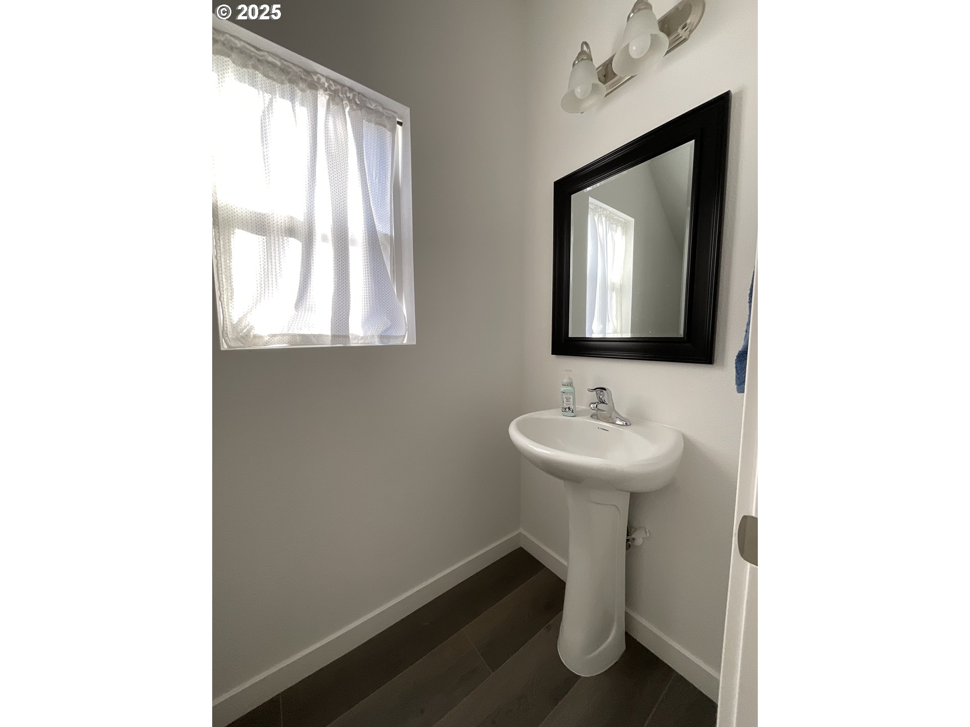 857 South 25th Avenue Cornelius, OR 97113 - Photo 5 of 22 a bathroom with a sink a mirror and a window