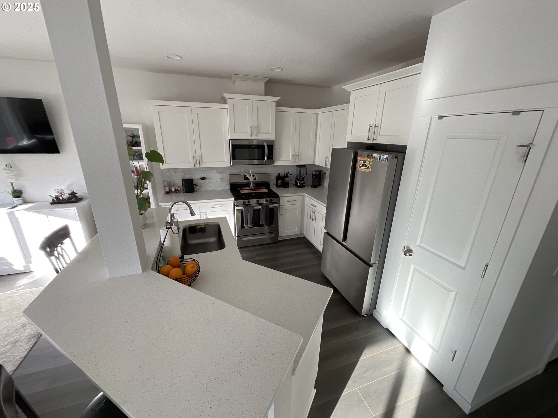 857 South 25th Avenue Cornelius, OR 97113 - Photo 7 of 22 a view of a kitchen with fridge and wooden floor