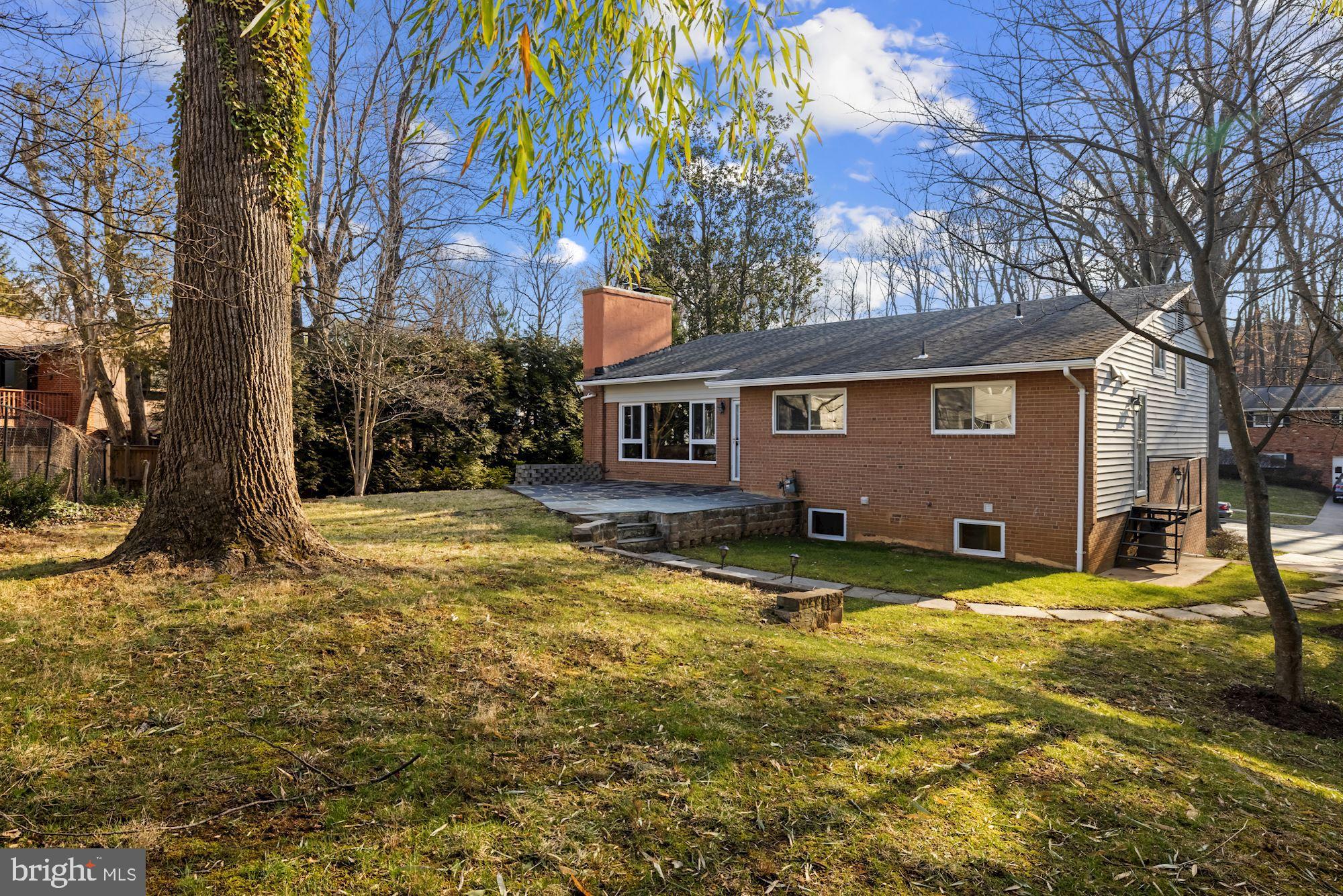 7716 Beech Tree Road Bethesda, MD 20817 - Photo 48 of 49 a view of a house with a yard and garage