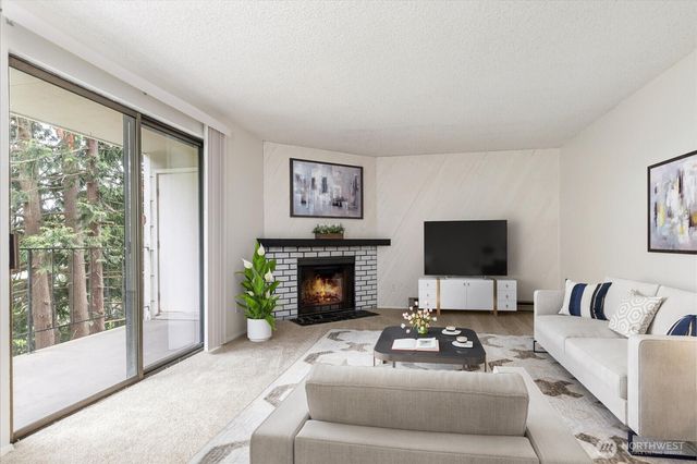 a living room with furniture a fireplace and a flat screen tv