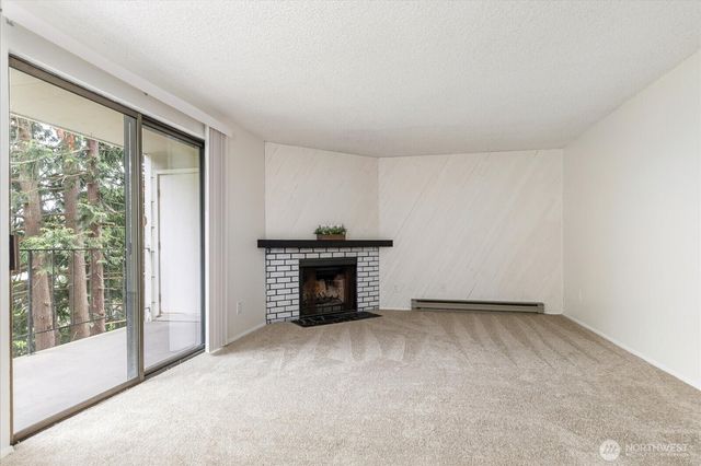 an empty room with a fireplace and a window