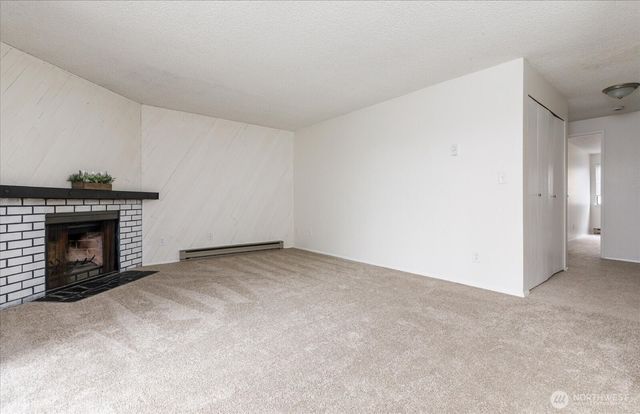 a view of empty room with a fireplace