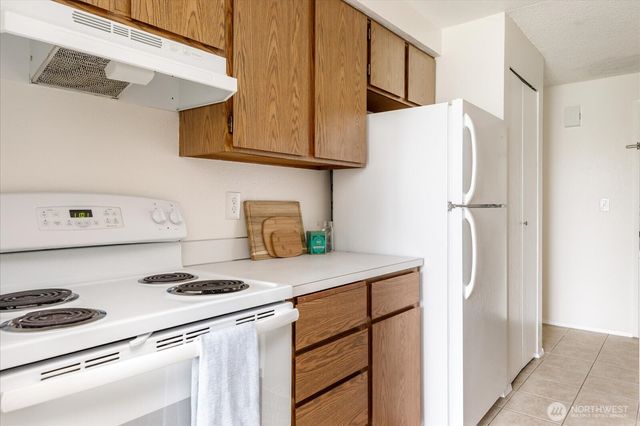 a kitchen with stainless steel appliances a refrigerator and a stove