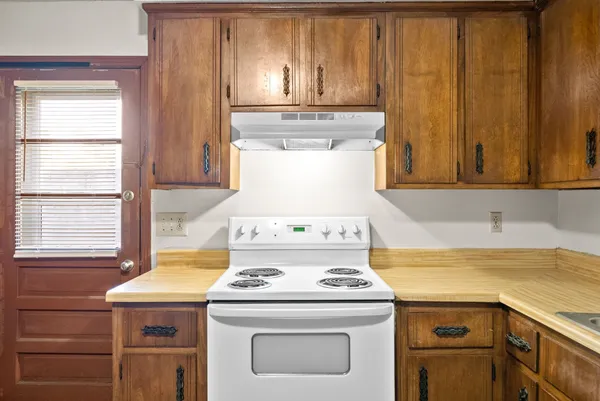 a view of a kitchen with a stove top oven