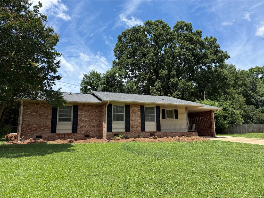 1507 East Calhoun Street Anderson, SC 29621 - Photo 2 of 18 A well-maintained brick facade and verdant front yard provide appealing curb appeal.