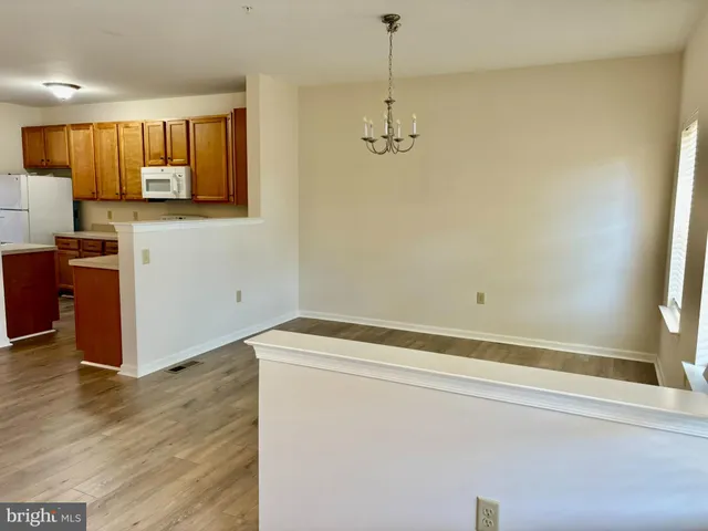 a view of a kitchen with a sink wooden floor and a window