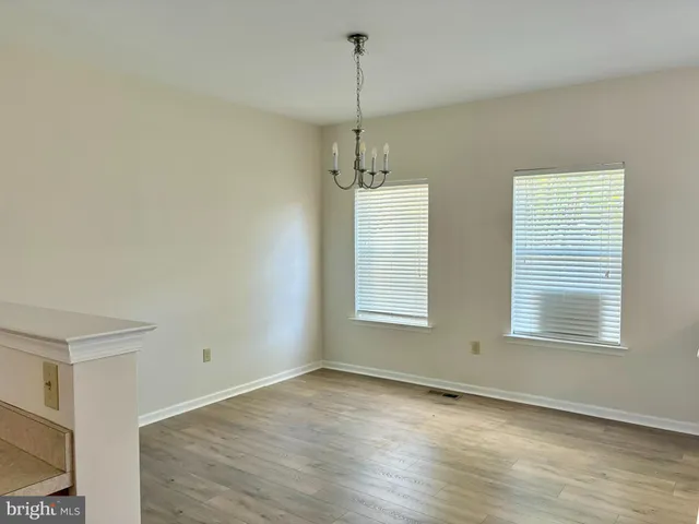 a view of a room window and wooden floor