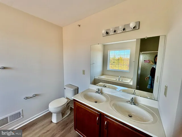 a bathroom with a sink mirror and toilet