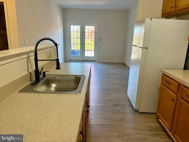 a kitchen with a refrigerator sink and cabinets