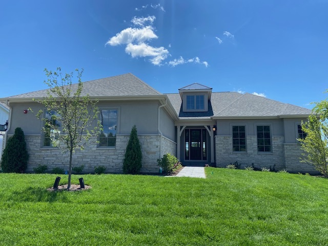 a view of a house with a backyard
