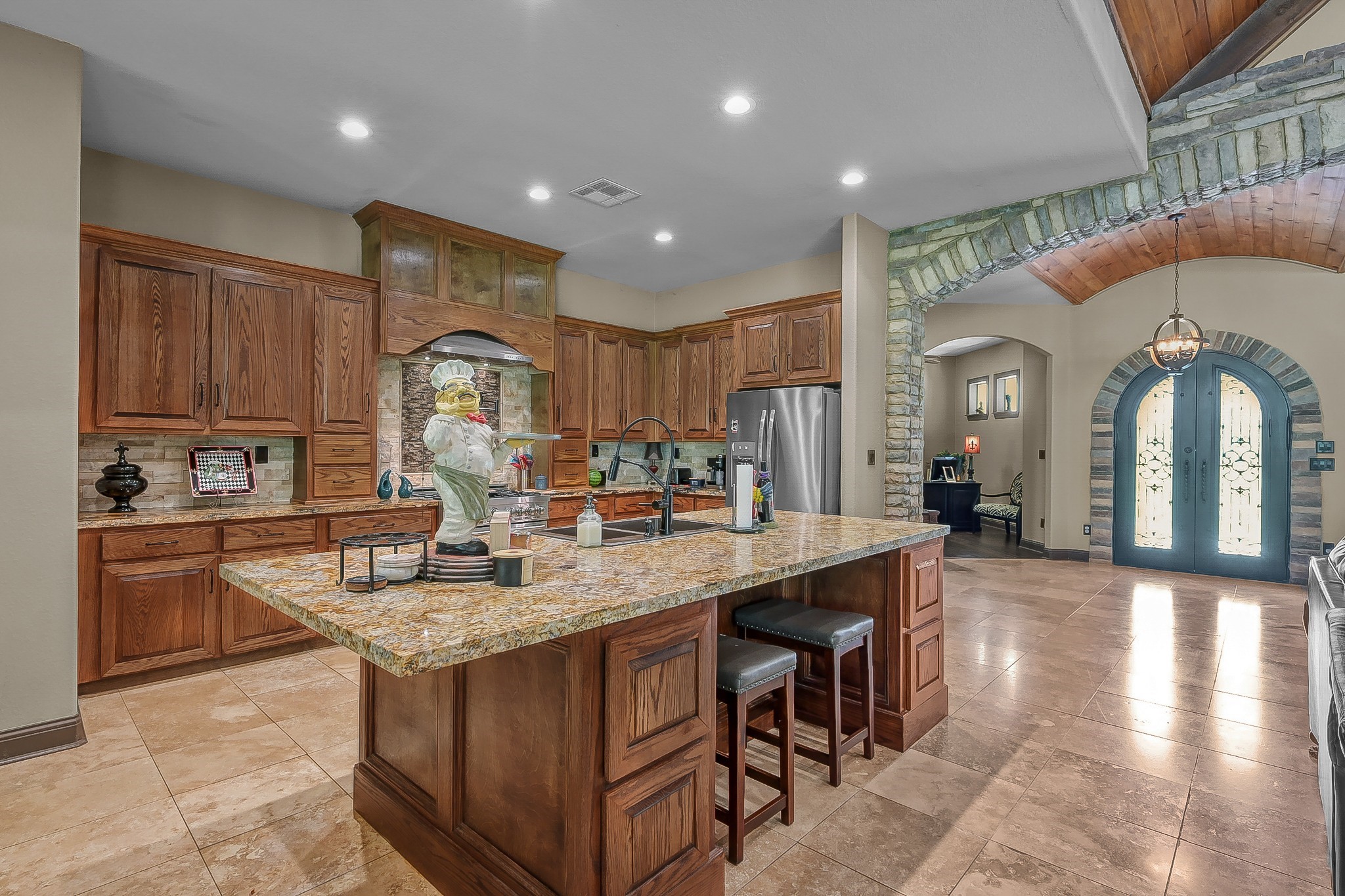 1183 Jones Road New Waverly, TX 77358 - Photo 18 of 40 a large kitchen with kitchen island a sink a stove and a center island