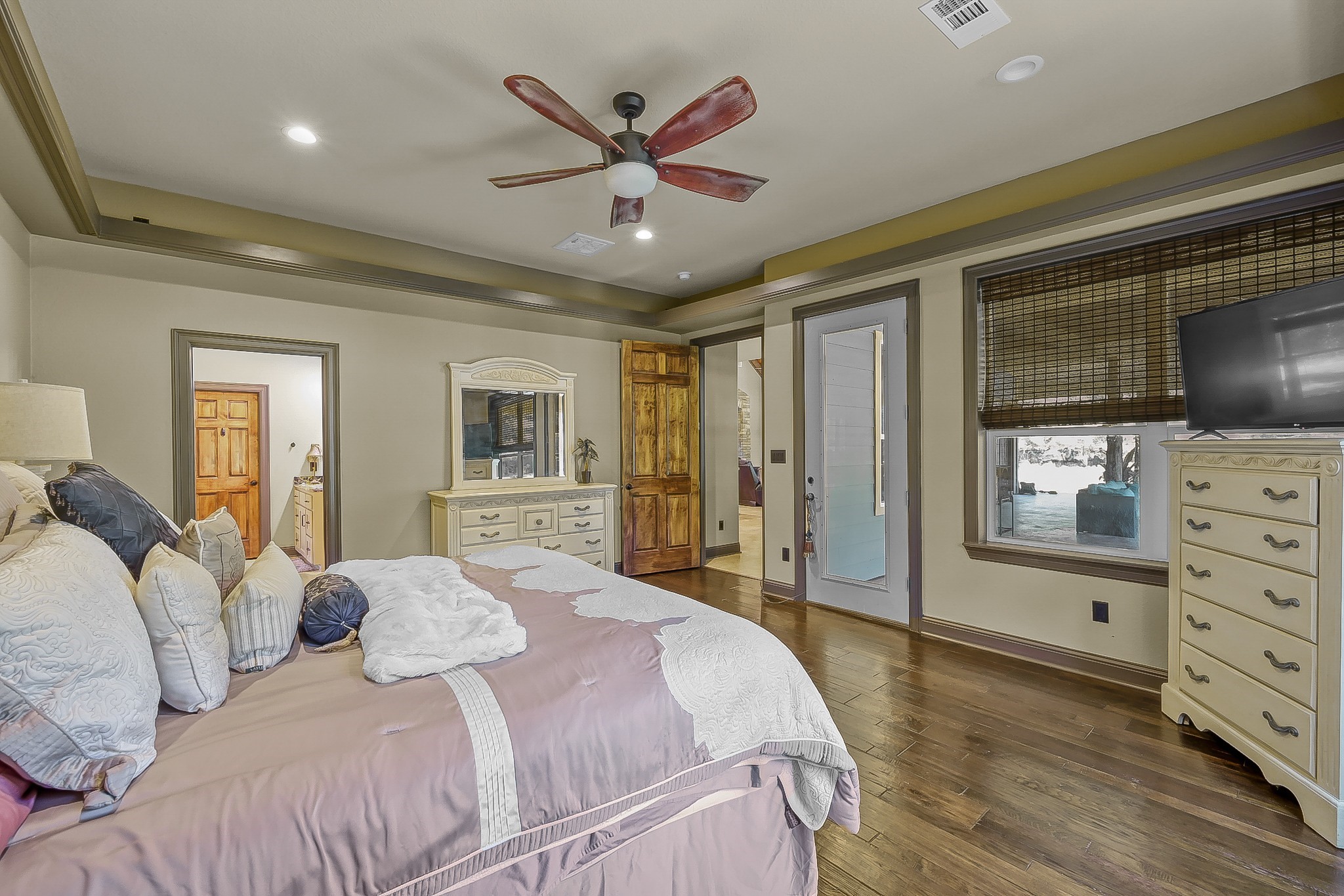 1183 Jones Road New Waverly, TX 77358 - Photo 22 of 40 a bedroom with a large bed and a flat screen tv