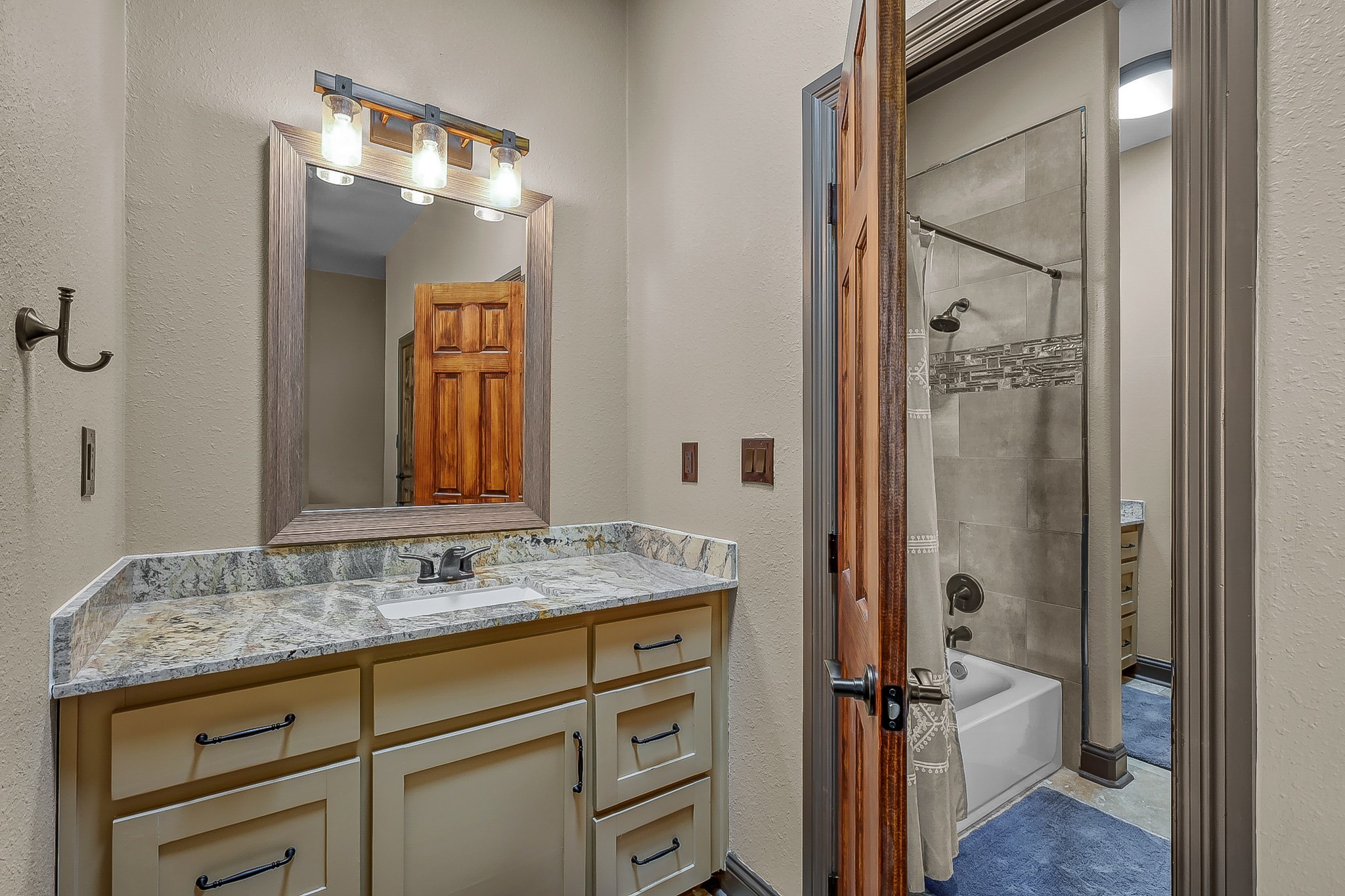1183 Jones Road New Waverly, TX 77358 - Photo 27 of 40 a bathroom with a granite countertop sink and a mirror