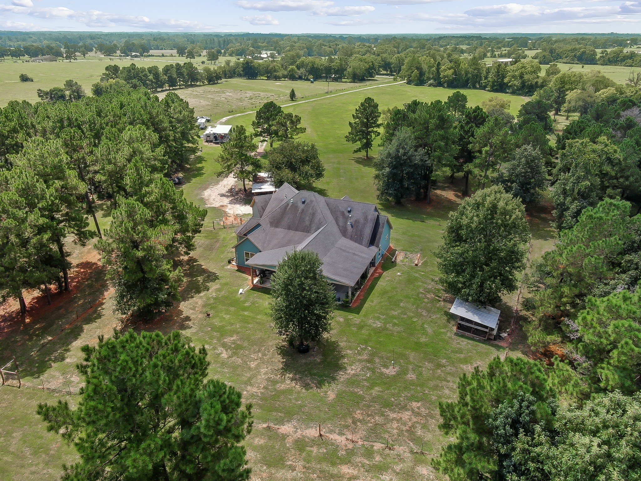 1183 Jones Road New Waverly, TX 77358 - Photo 3 of 40 an aerial view of lake residential house with outdoor space and trees around
