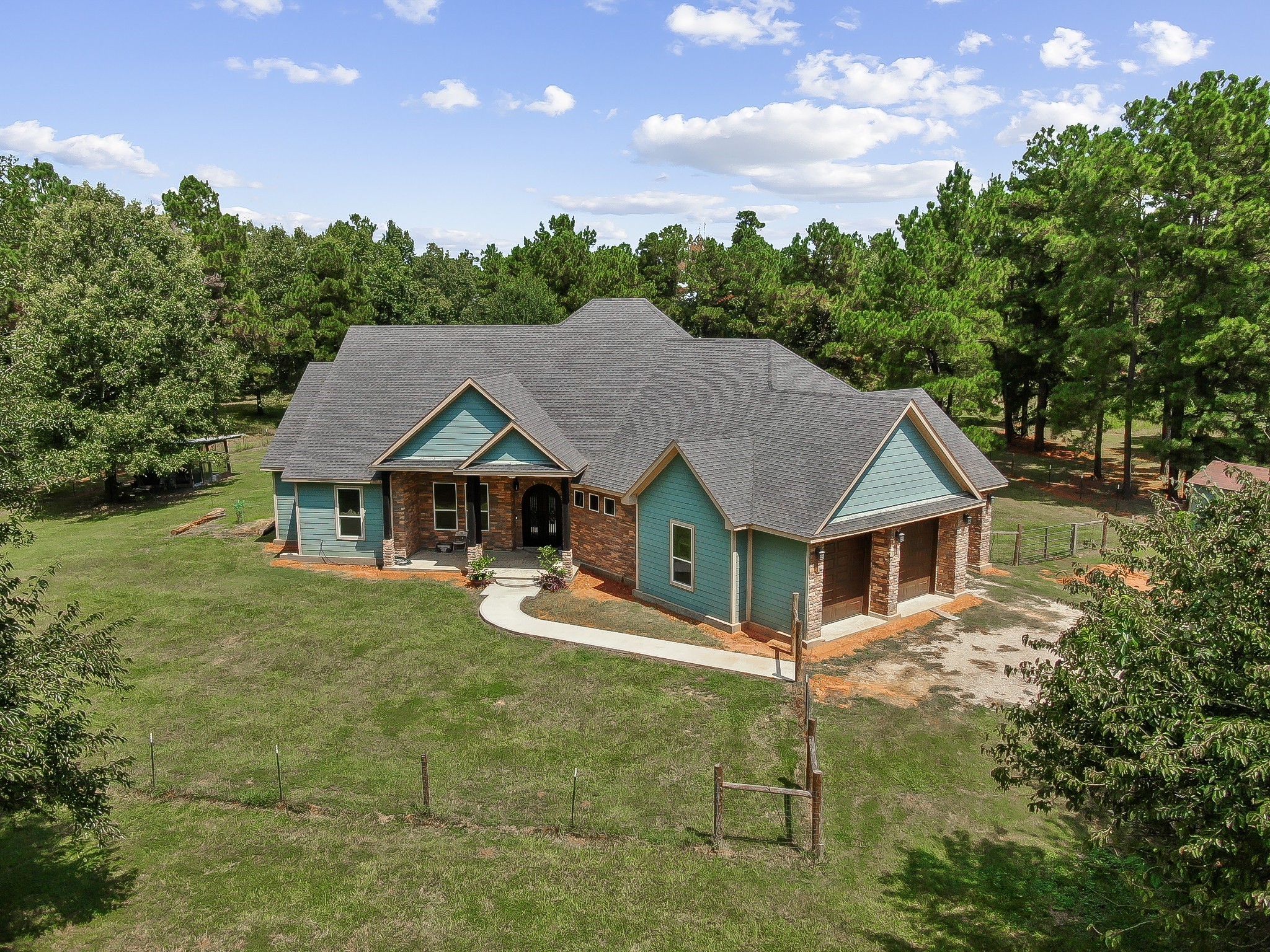 1183 Jones Road New Waverly, TX 77358 - Photo 4 of 40 a front view of a house with garden