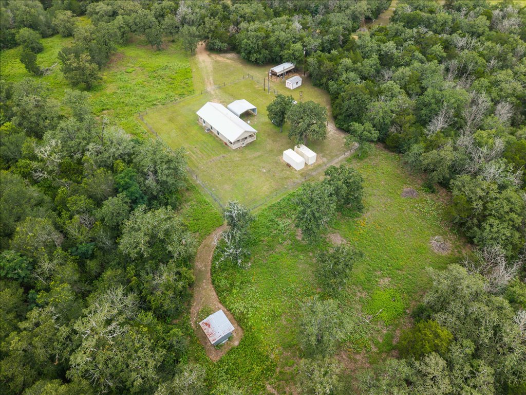 608 Whistleville Road Flatonia, TX 78941 - Photo 20 of 26 You can see the little path leading down to an extra outbuilding tucked into the trees.