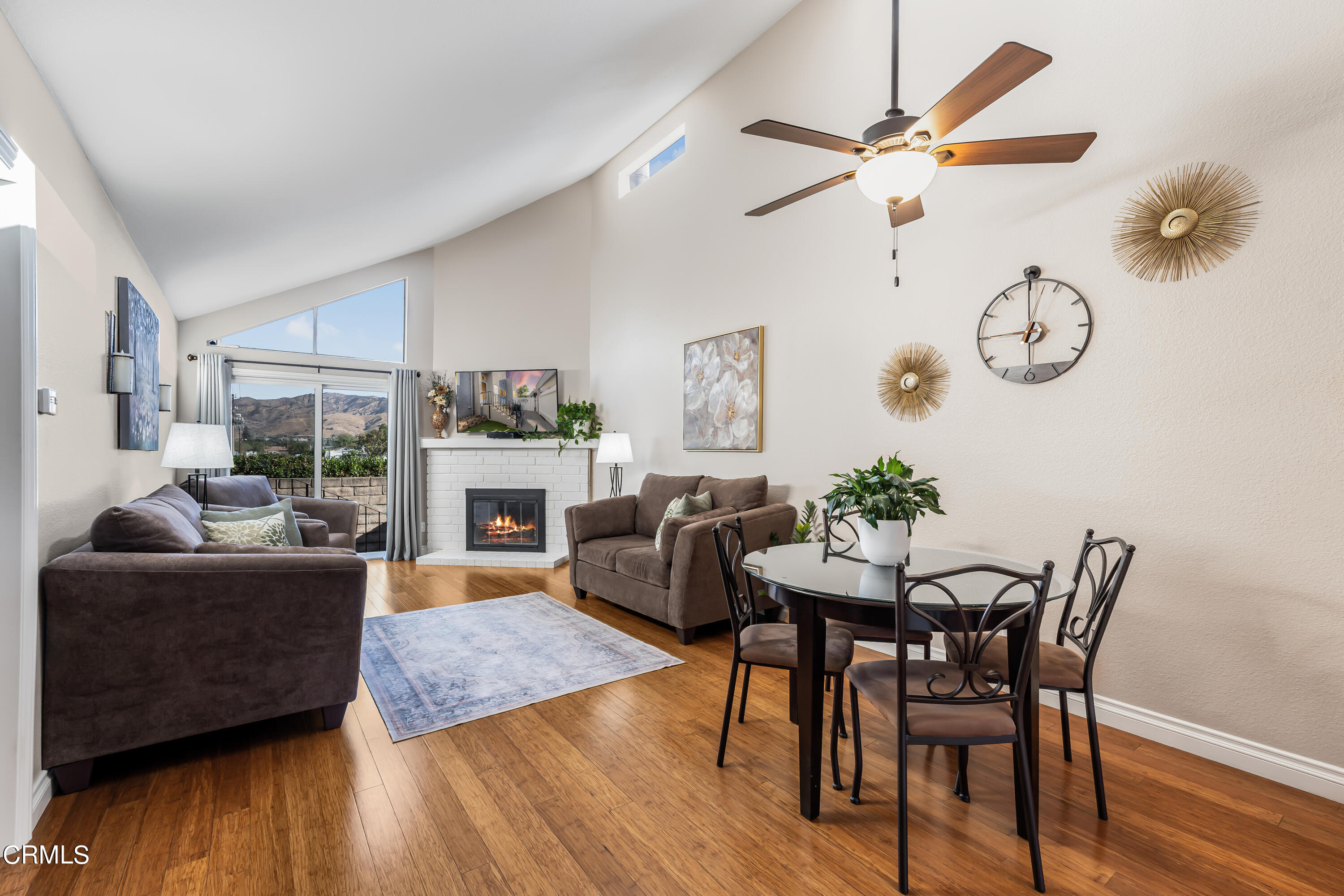 6392 Katherine Road, Unit B Simi Valley, CA 93063 - Photo 1 of 26 a view of a livingroom with furniture a fireplace wooden floor and a chandelier