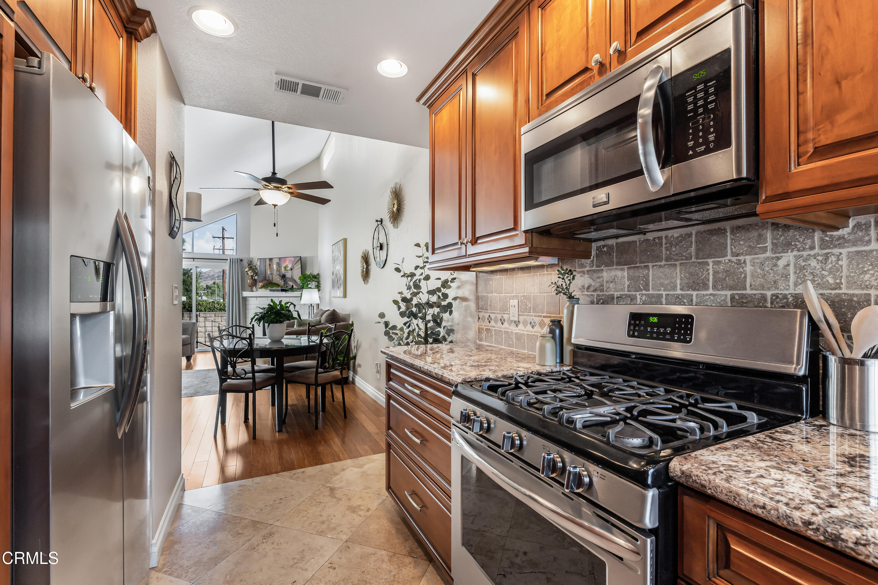 6392 Katherine Road, Unit B Simi Valley, CA 93063 - Photo 9 of 26 a kitchen with stainless steel appliances granite countertop a stove top oven a refrigerator and a sink