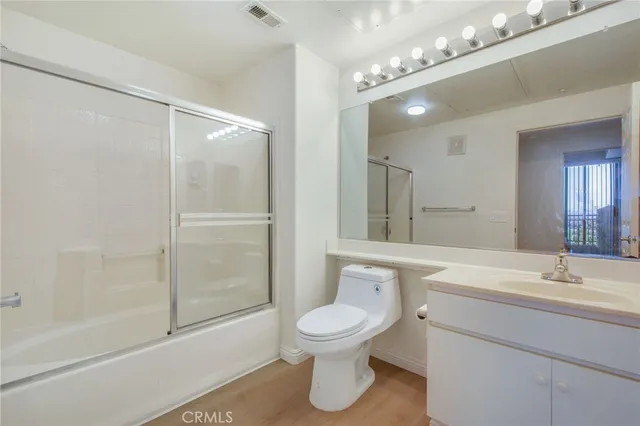a bathroom with a toilet a sink and a mirror