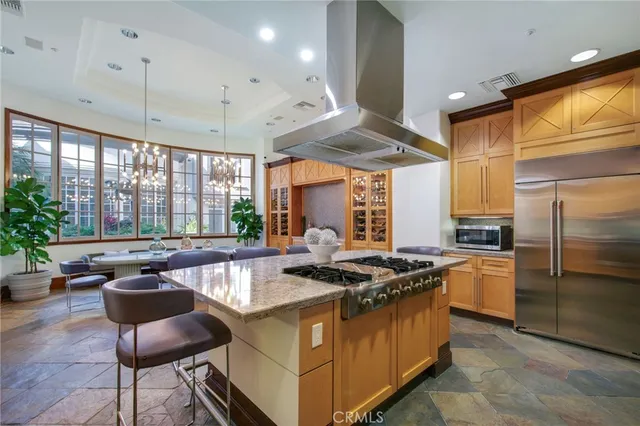 a kitchen with stainless steel appliances granite countertop a stove a sink and a refrigerator