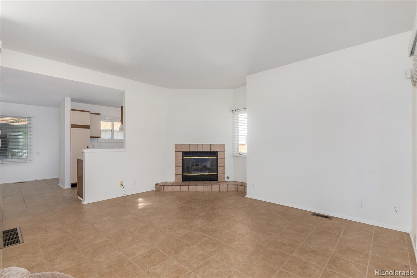 515 Cook Street Denver, CO 80206 - Photo 12 of 40 an empty room with floor to ceiling window and fireplace